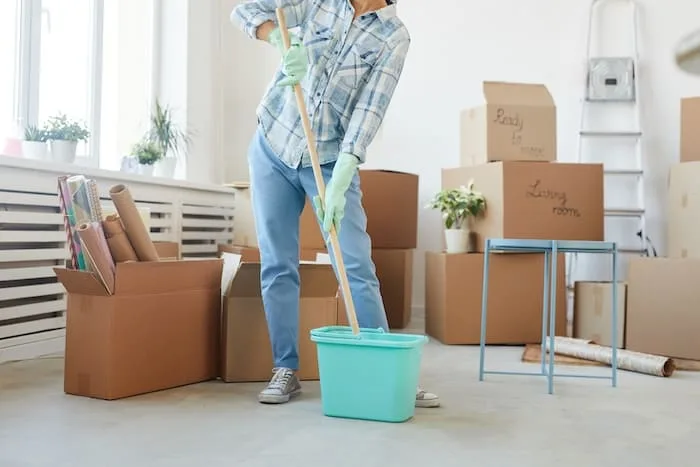 low-section-portrait-happy-young-woman-cleaning-new-house-apartment-while-moving (1)